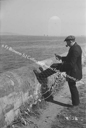 FISHERMAN MENDING NETS